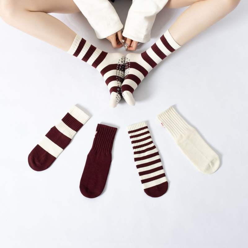 Burgundy and white custom Pilates grip socks for yoga and wellness programs