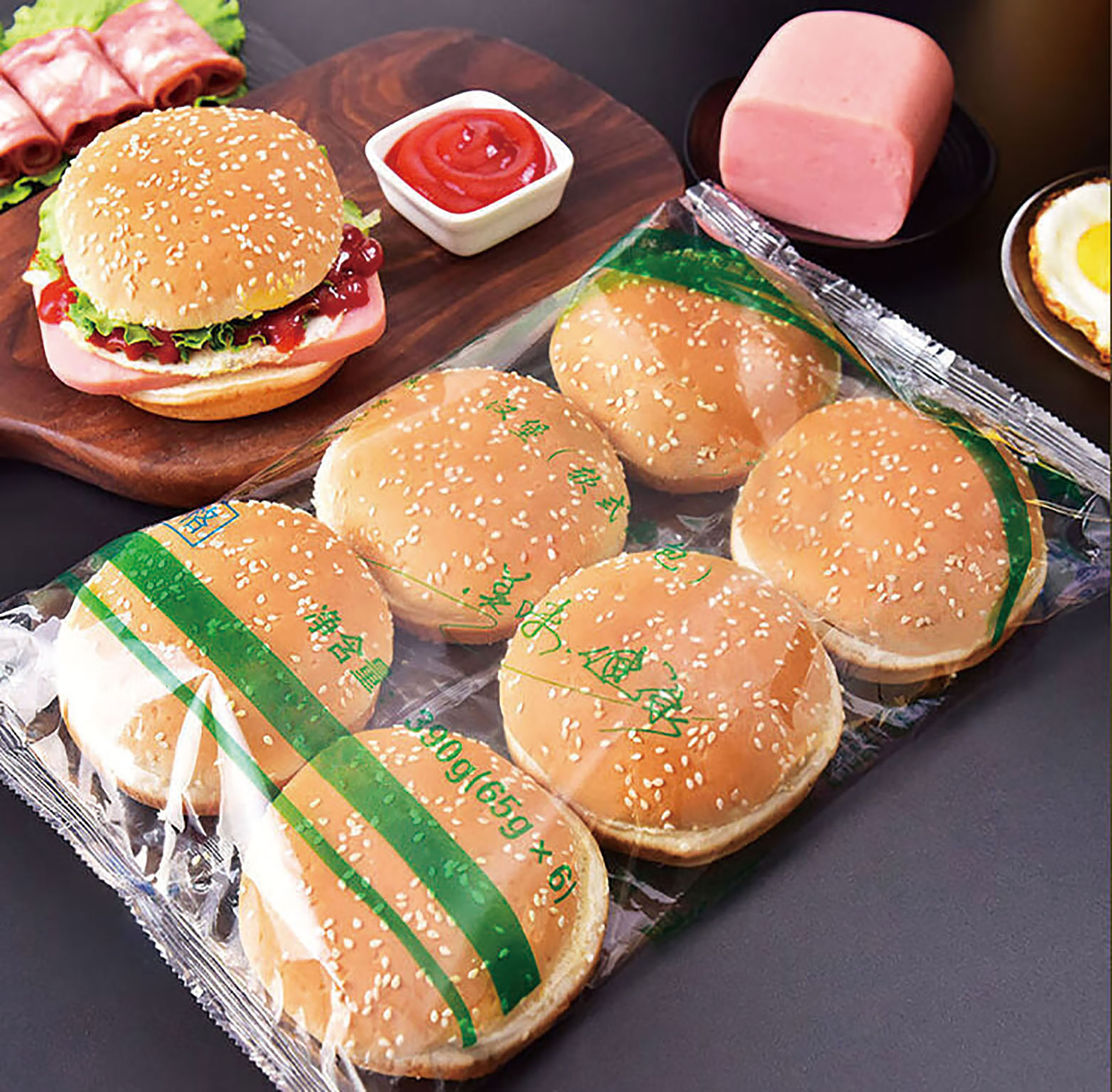 Detail view of the hamburger flow wrapper and patty interleaving and stacking mechanism