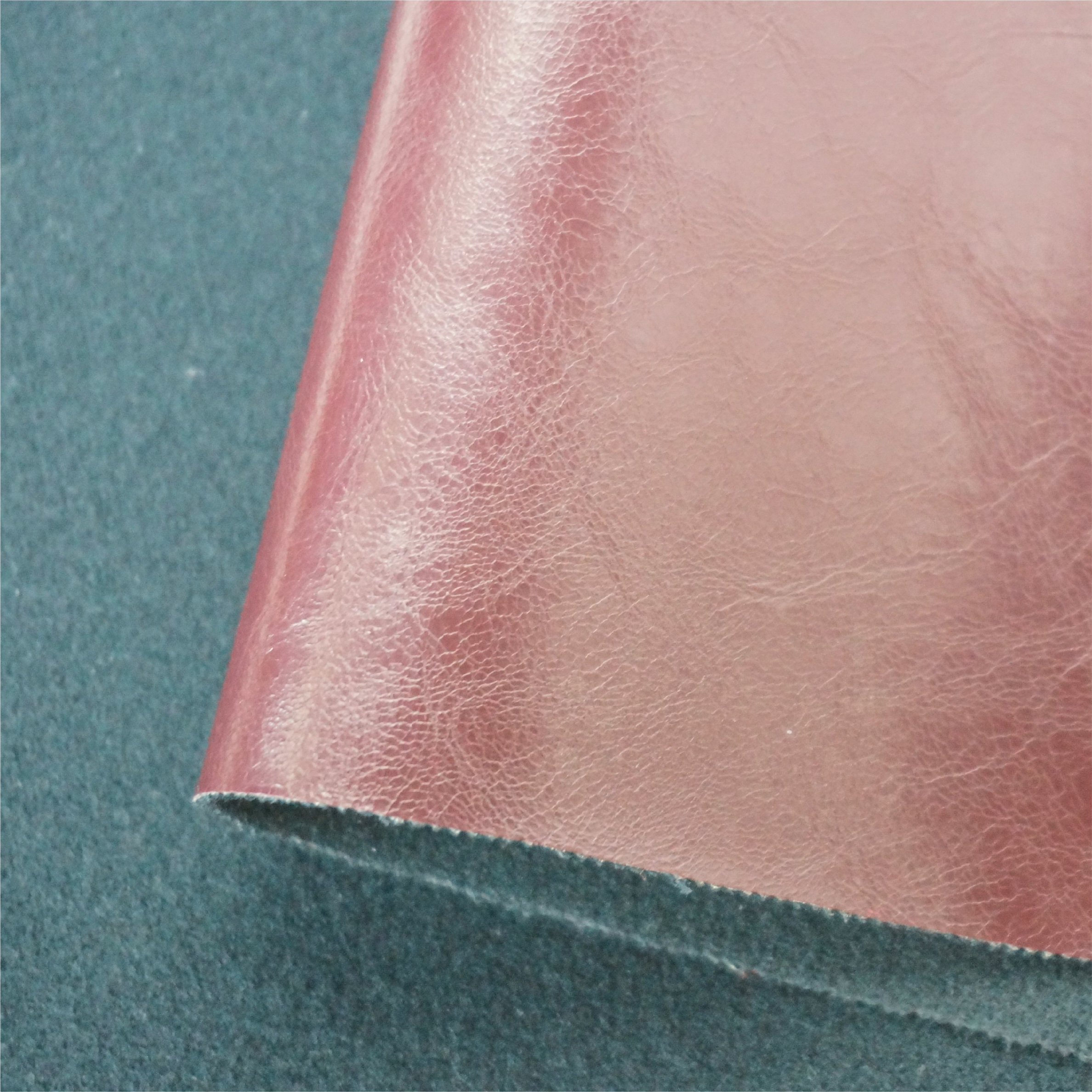 Roll of solvent-free PU leather showing flexible backing fabric and thickness